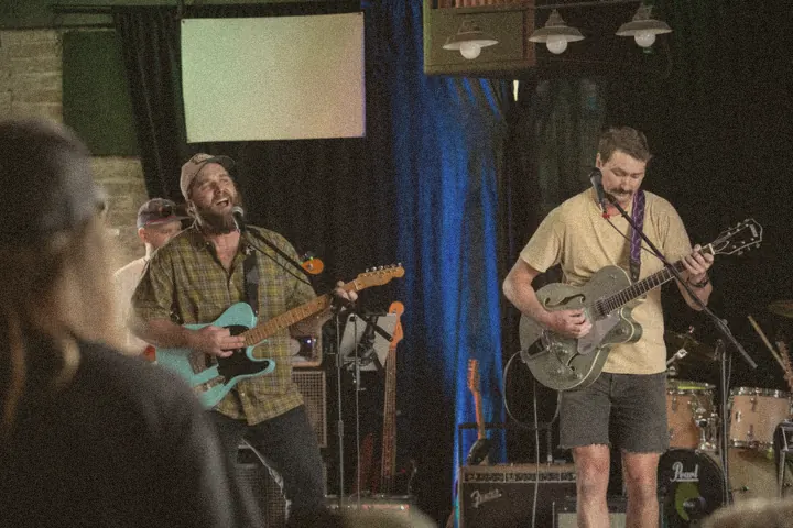 Zig Zag Wanderers on stage: two guitarists singing during a live show